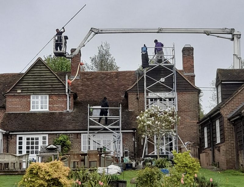 The Moss Cleaners using cherry picker and scaffolding to clean roof safely and professionally in 8 Chertsey Rd, Shepperton TW17 9LB, UK, 8 Chertsey Rd, Shepperton TW17 9LB, UK
